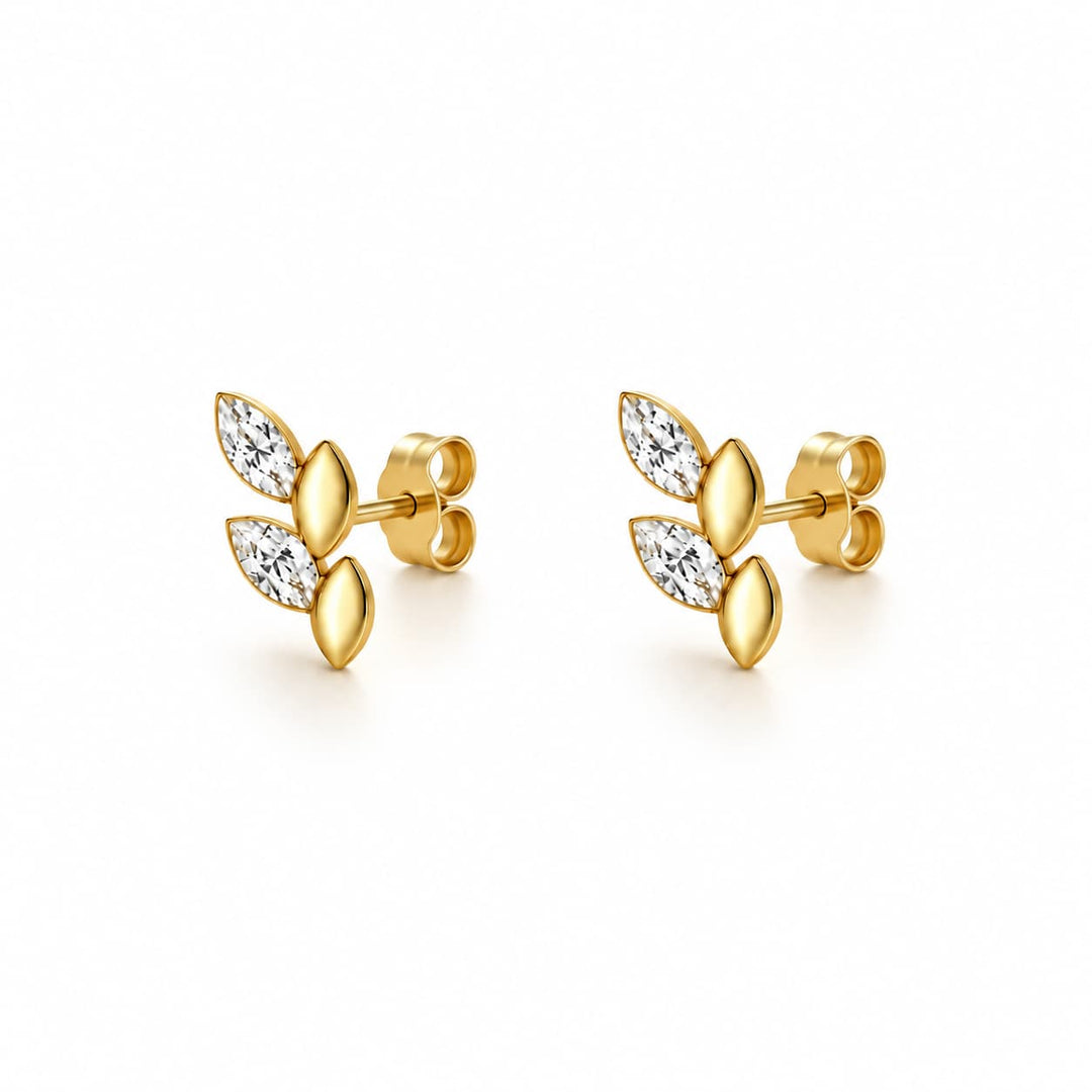 A pair of gold leaf stud earrings with marquise-cut clear stones, shown on a clean white background.