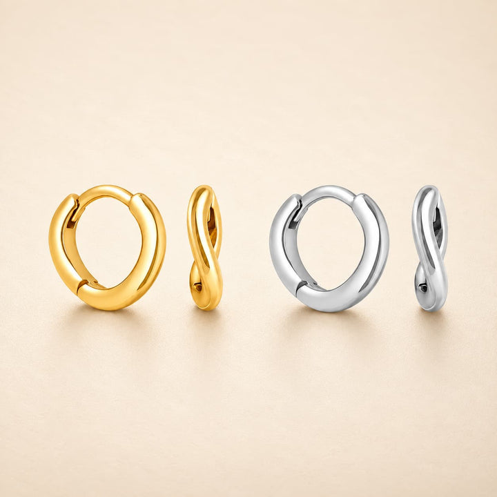Four twisted hoop earrings in polished yellow gold and silver, arranged in pairs on a warm beige background.