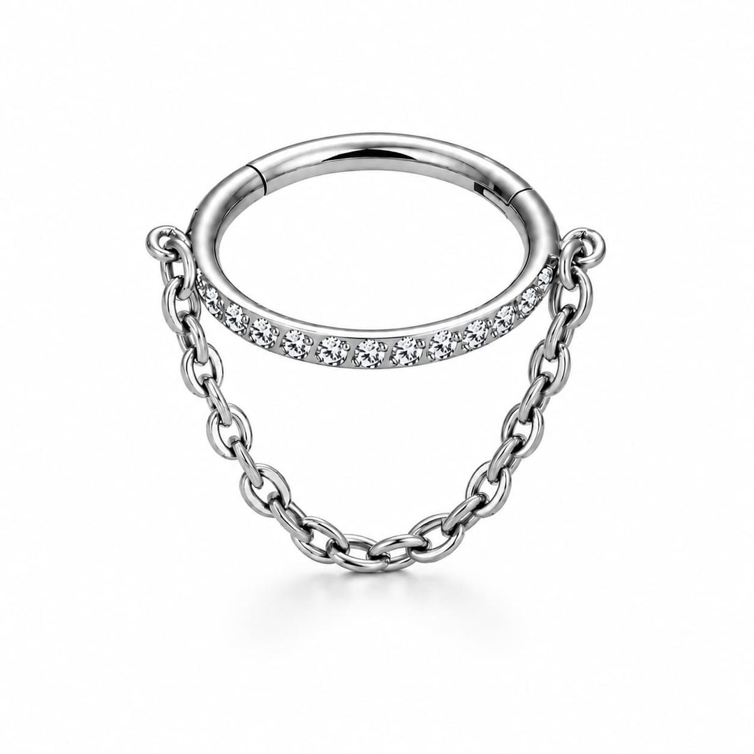 A silver ring with a small curved chain dangle. The top of the chain is embellished with a row of clear cubic zirconia stones, set against a clean white background.