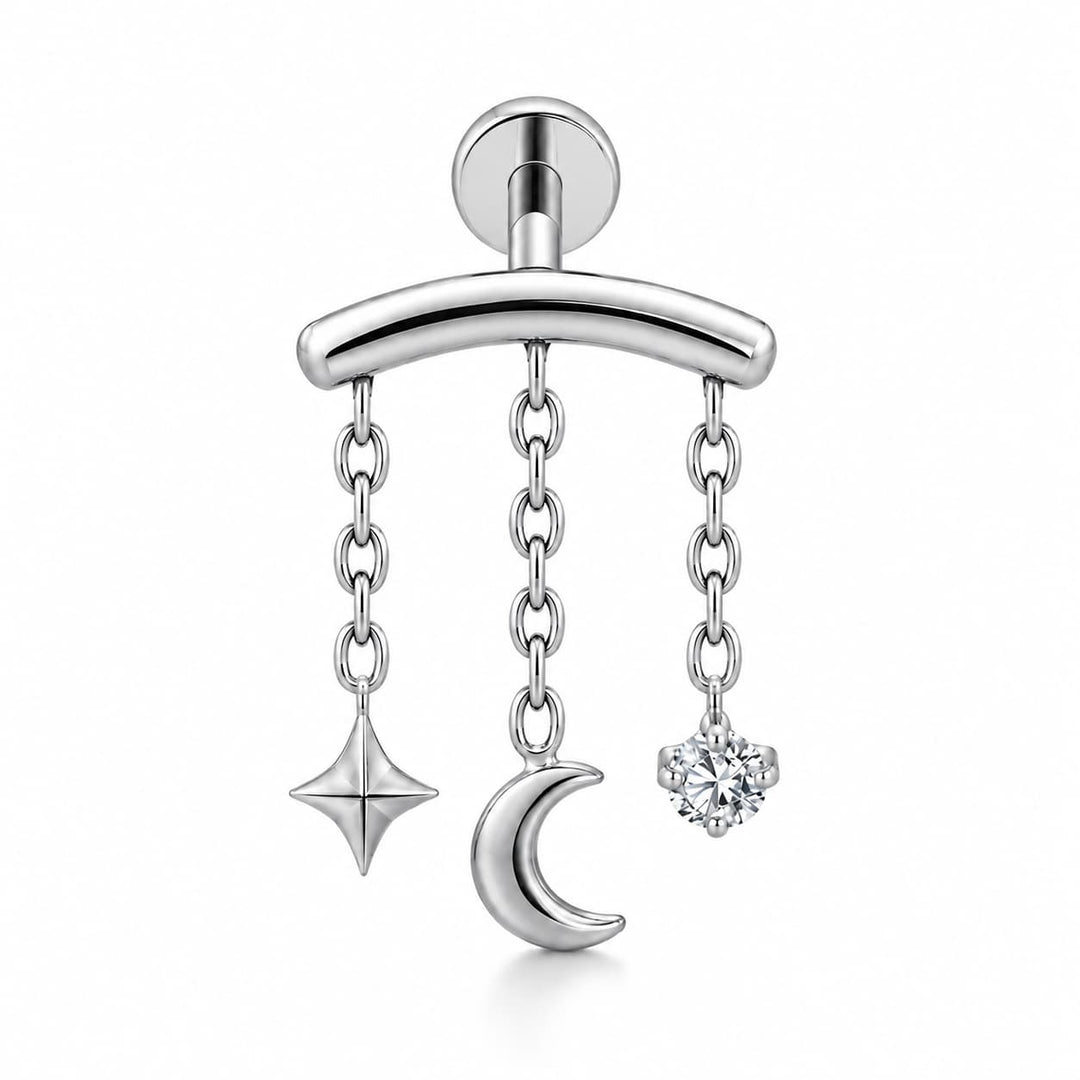 A silver-toned barbell earring featuring three dangling chain charms: a four-pointed star, a crescent moon, and a round clear gemstone, shown on a clean white background.
