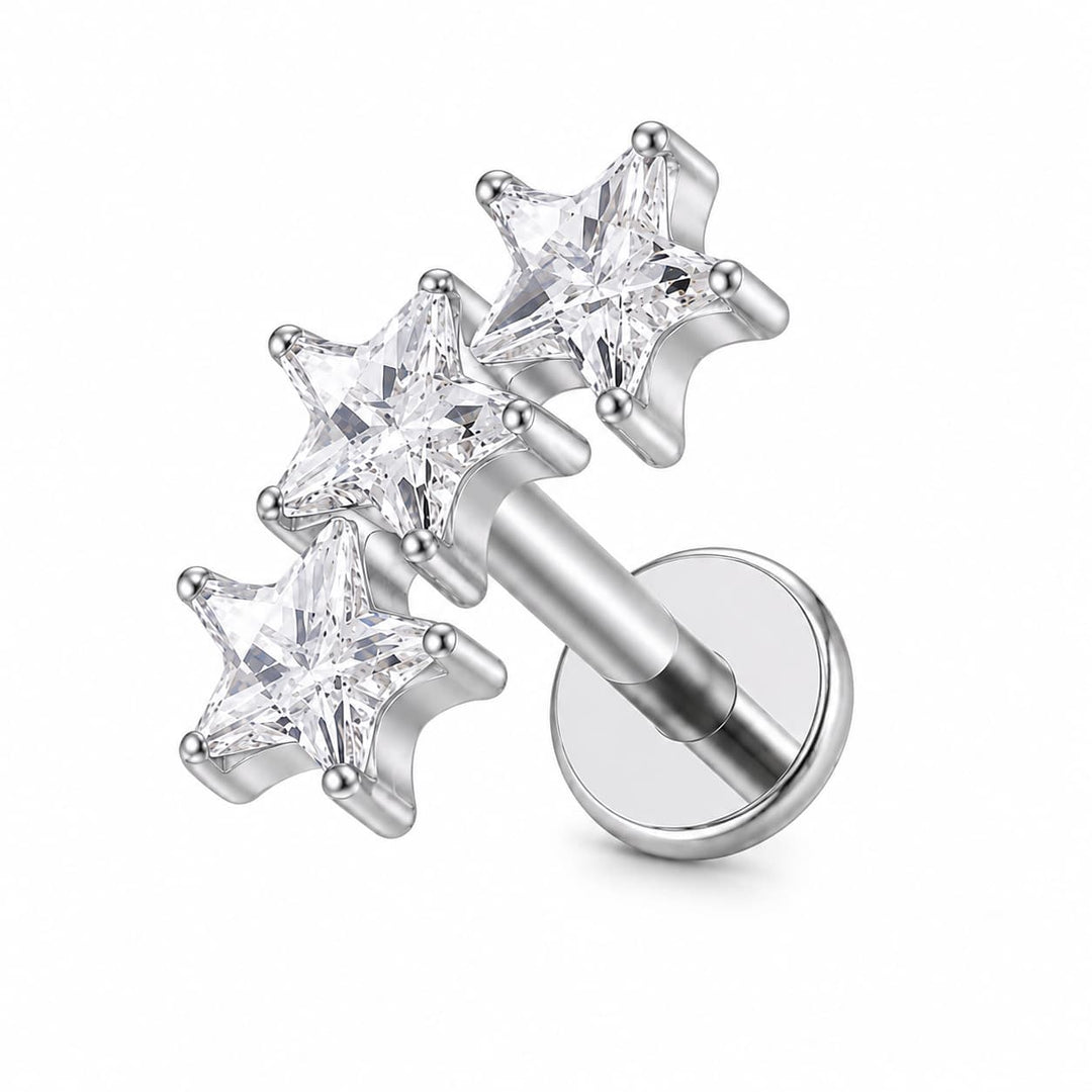 Silver-toned labret piercing stud with three clear faceted star-shaped gemstones on a white background.